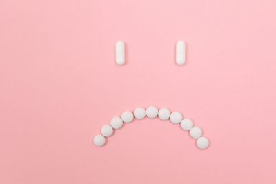 Directly above shot of multi colored pencils over pink background