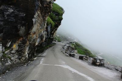 Road amidst mountains against sky