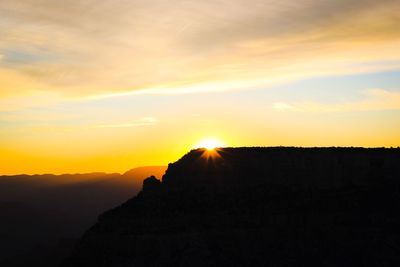 Scenic view of silhouette mountains against sky during sunset