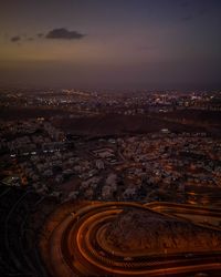 High angle view of illuminated buildings in city at night