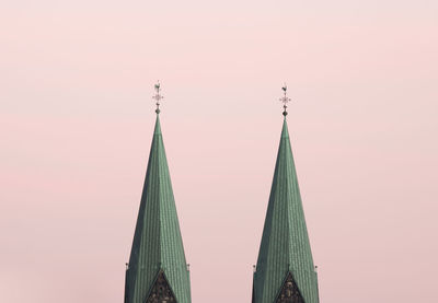 Low angle view of steeples against sky