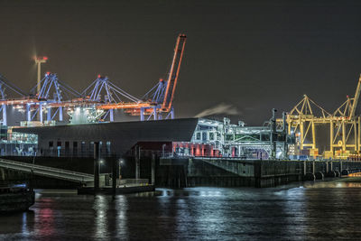 Commercial dock at port of hamburg against sky at night