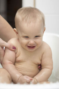 Close-up of mother hands bathing boy