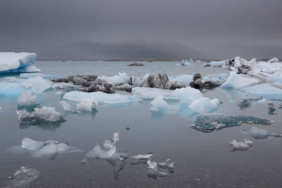 View of ice in lake against sky