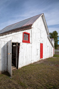 Exterior of old house on field against sky