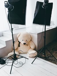 Teddy bear by lighting equipment at studio