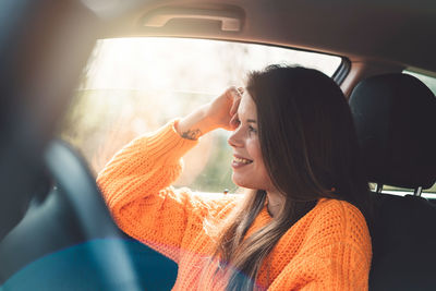 Portrait of young woman in car