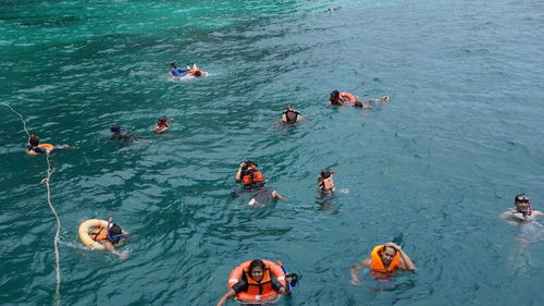 High angle view of people swimming in sea