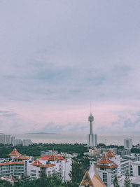 High angle view of buildings against cloudy sky