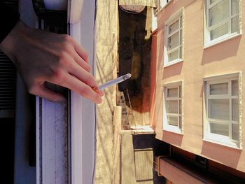 Close-up of man hand holding window