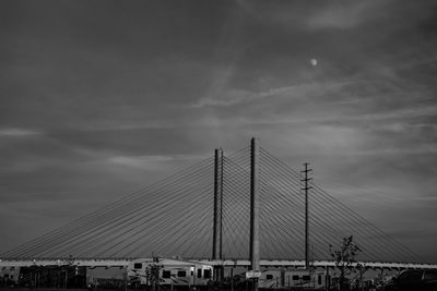 Low angle view of bridge against cloudy sky