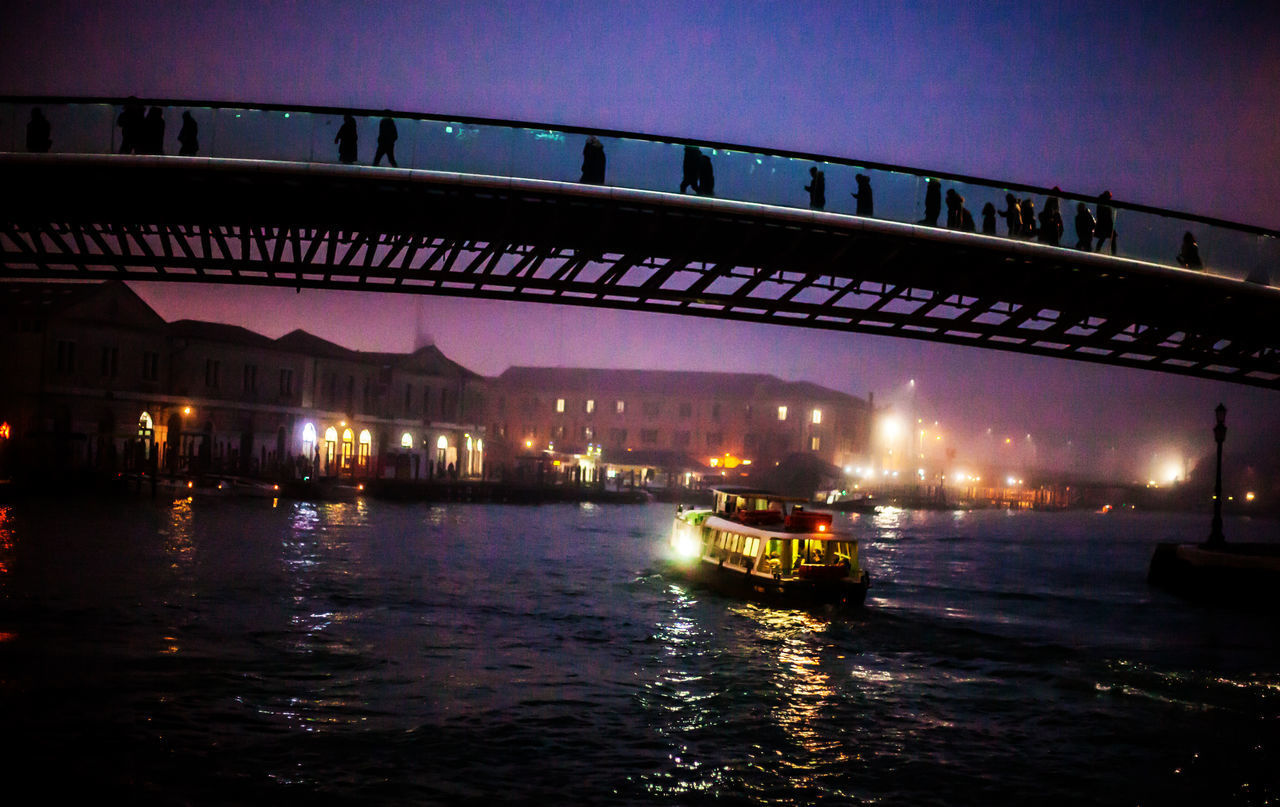 BRIDGE OVER RIVER AT NIGHT