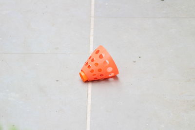 Close-up of orange plastic equipment on floor