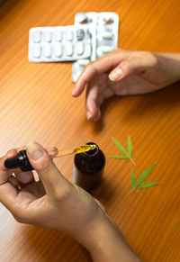 High angle view of woman holding hands on table