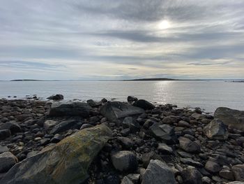 Rocks on beach against sky