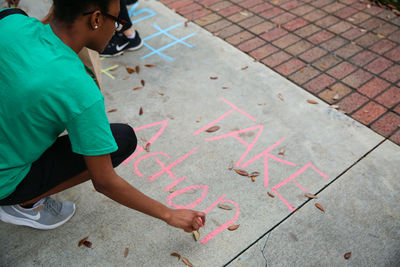 Boy playing on sidewalk