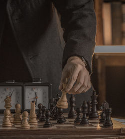 Midsection of man playing chess