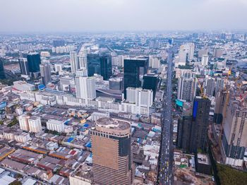 High angle view of modern buildings in city against sky