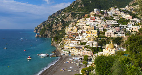 High angle view of townscape by sea against sky