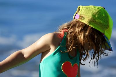 Close-up of girl by sea