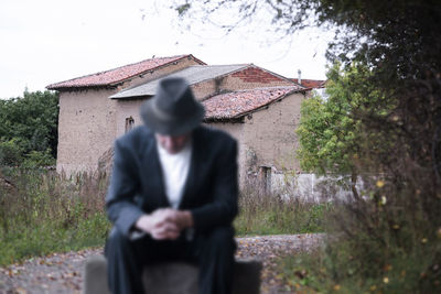 Rear view of man standing against trees