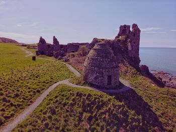 Stone wall with sea in background