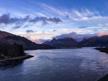 Scenic view of lake and mountains against sky
