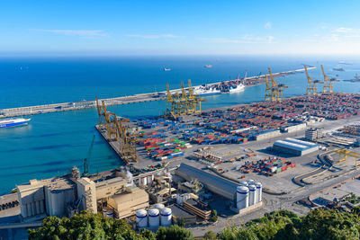 High angle view of city by sea against sky