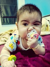 Close-up portrait of cute boy eating food