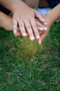 Close-up of hands on grass