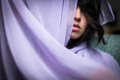 Close-up of woman wrapped in purple fabric