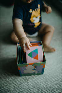 Boy playing with toy on flooring