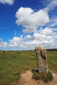 Hay bales on field against sky