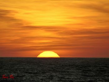 Scenic view of beach against sky during sunset