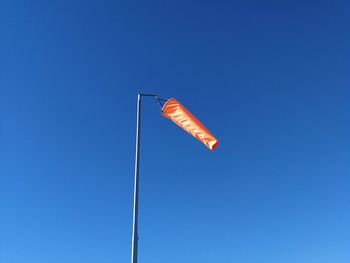 Low angle view of street light against clear blue sky