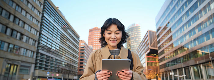 Portrait of young woman using digital tablet