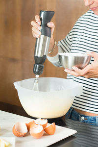 Cropped hand of person preparing food on table