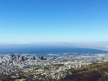 High angle view of cityscape against blue sky