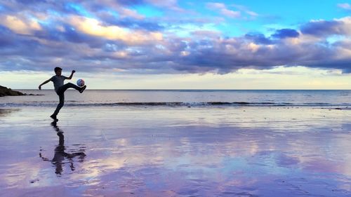 Scenic view of sea against cloudy sky