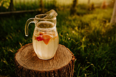 Close-up of drink in jar on field