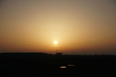 Scenic view of silhouette field against sky during sunset