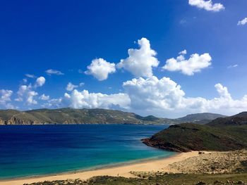 Scenic view of mykonos island against cloudy sky