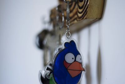 Close-up of toy hanging on wall