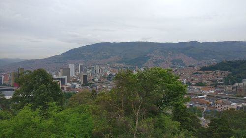 High angle view of buildings and trees against sky