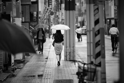 A woman walking with an umbrella