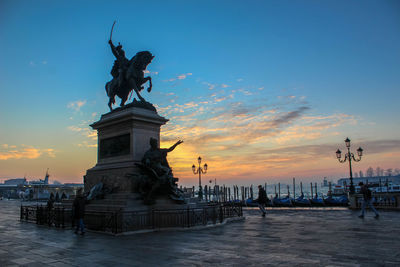 Low angle view of statue against blue sky