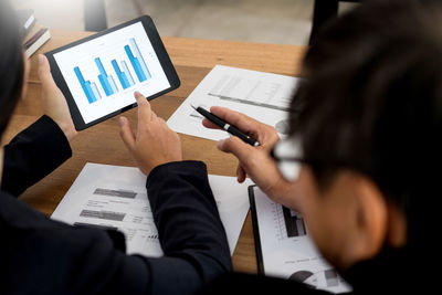 Rear view of woman working on table