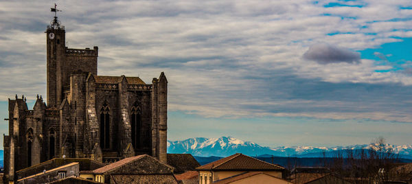 Historic building against cloudy sky