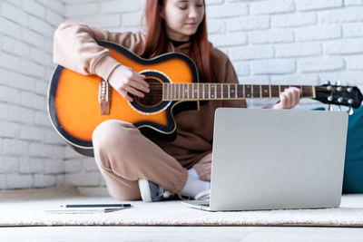 Young woman playing guitar