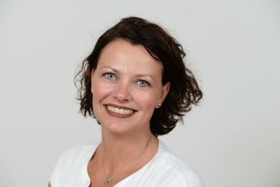 Portrait of smiling woman against white background